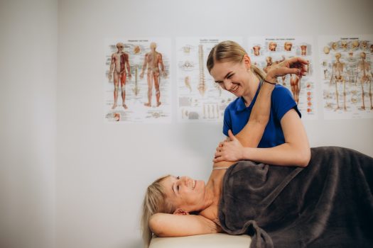 a retired woman visits a rehabilitation therapist for a massage